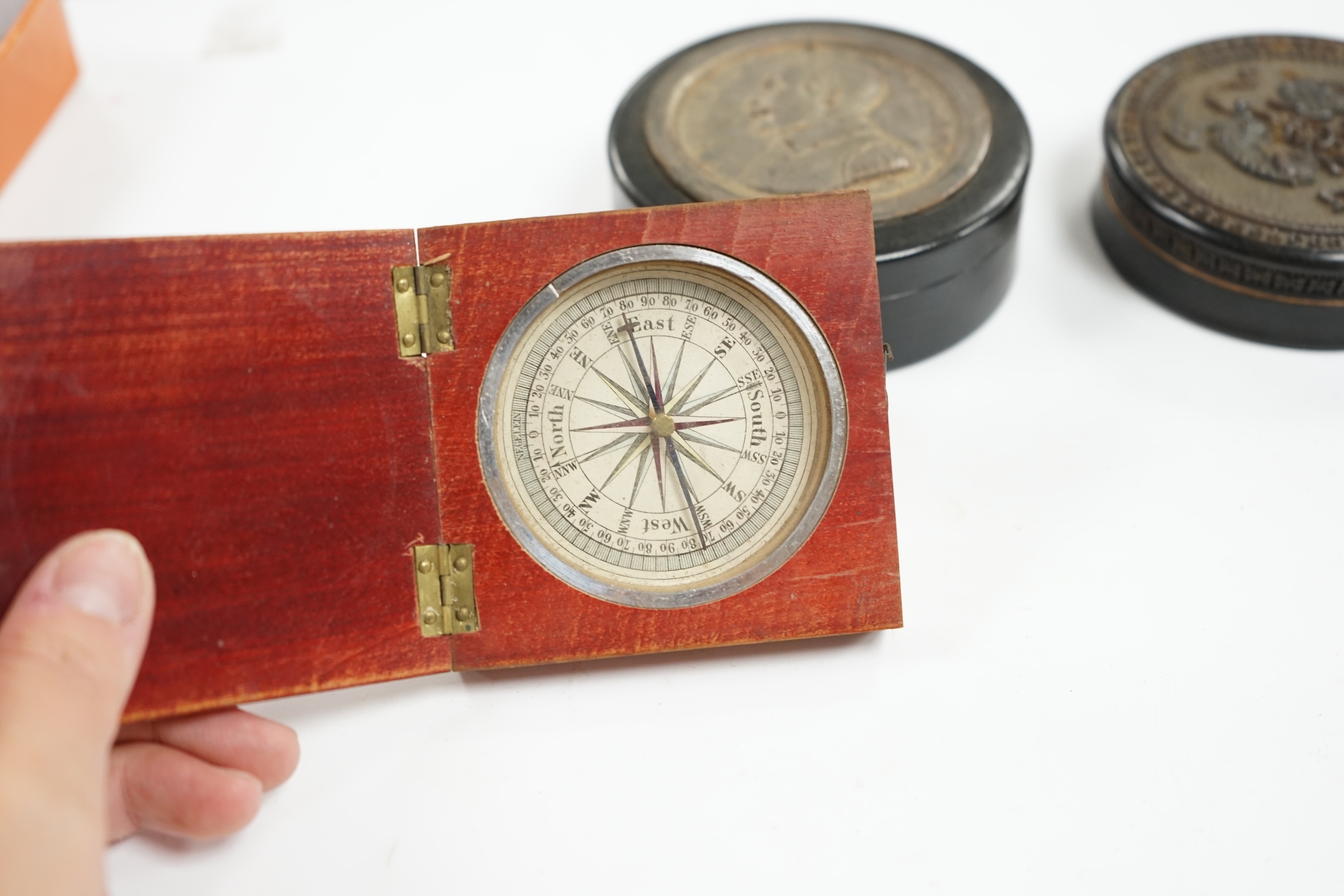 A carved wood case containing armorial crest, Tenax Justitiae, four other circular boxes and a portable compass etc, largest crest box 9.3cm diameter. Condition - mixed poor to fair